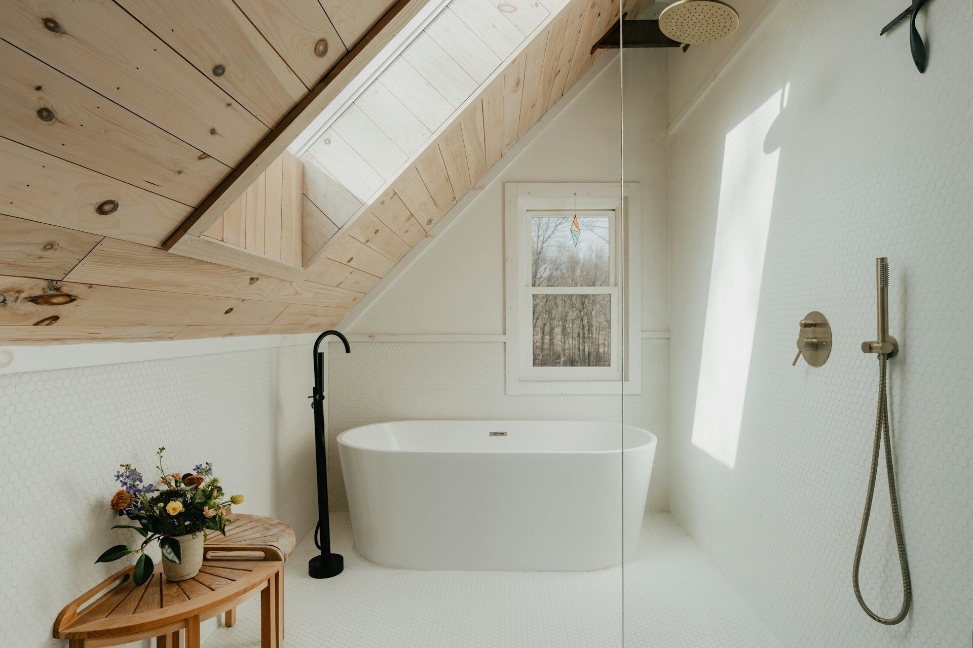 Elegant sunny bathroom with large bathtub