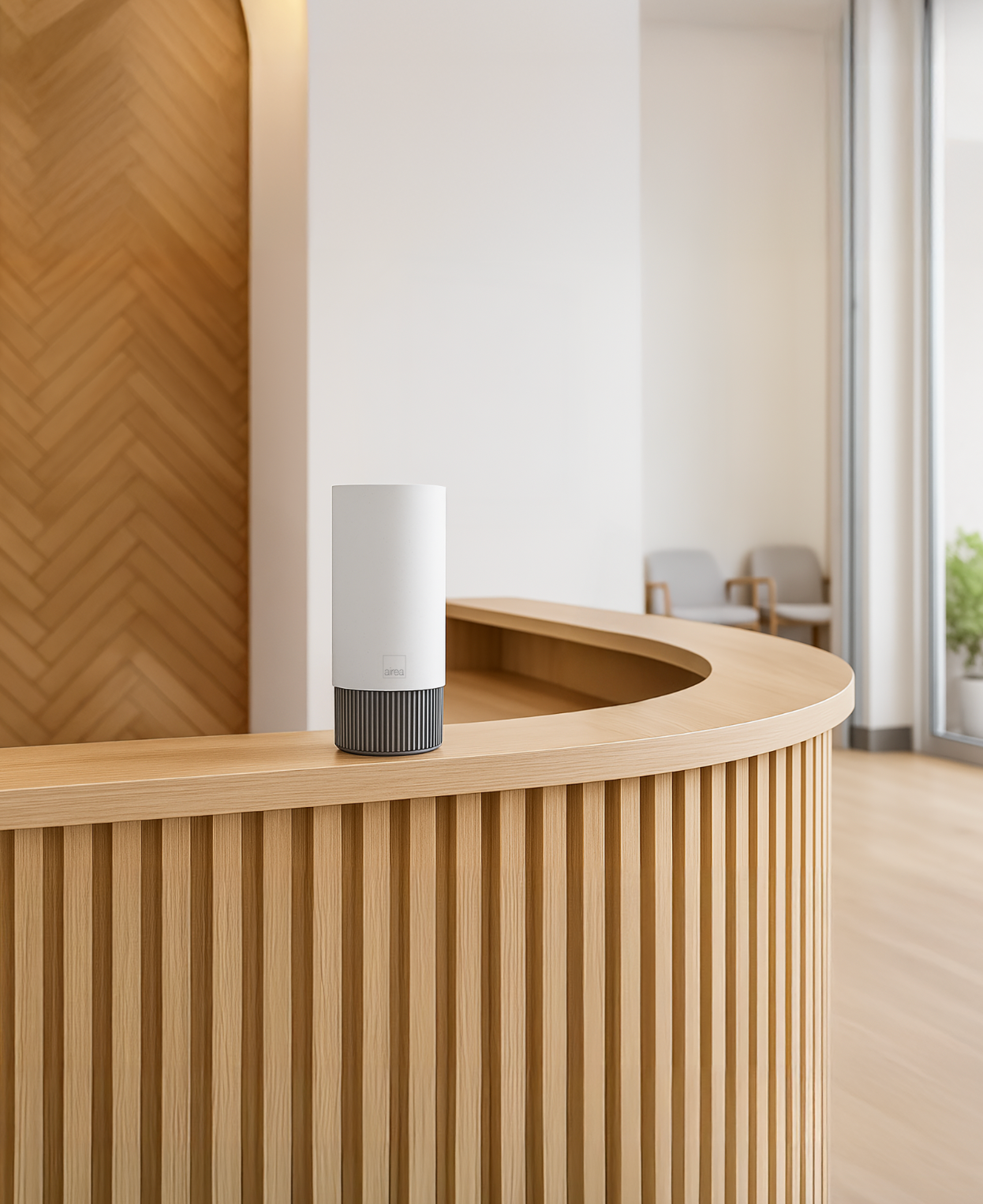A compact Airea Space Purifier sits on a minimal wood shelf in a medical waiting room, continuously protecting patients from airborne and surface contaminants.