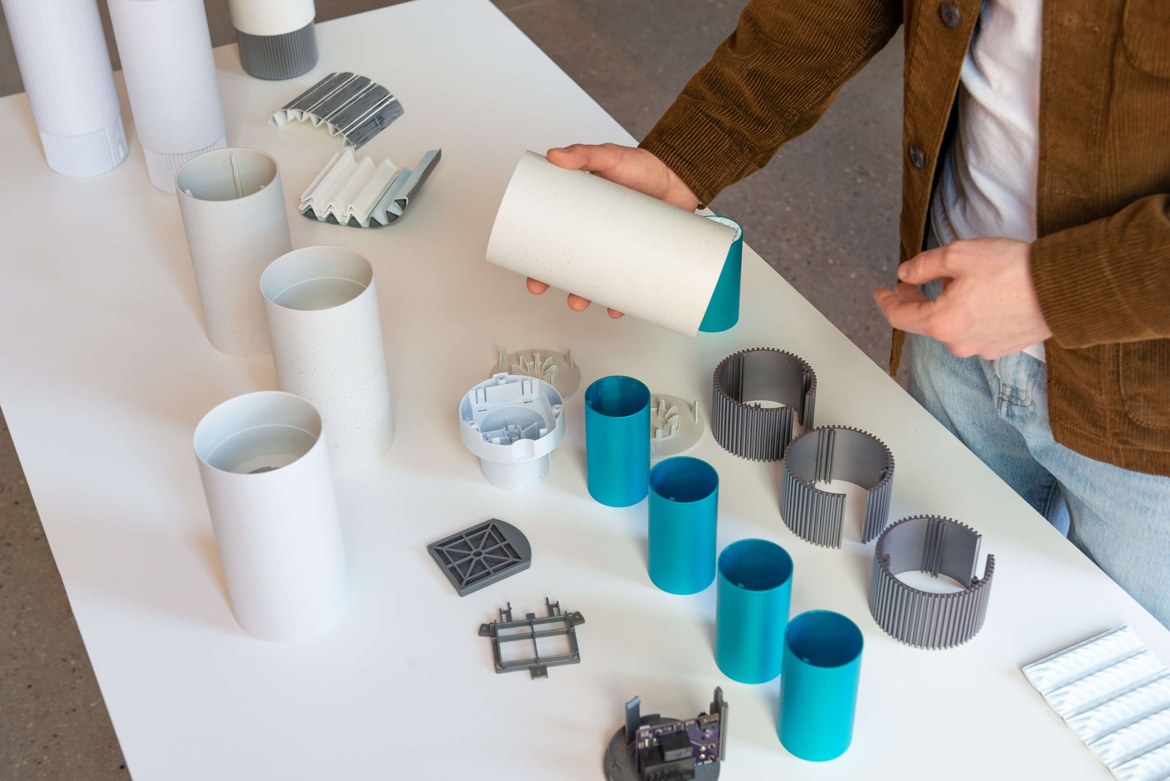 An industrial designer inspecting a prototype of the Airea Space Purifier on a table in a well-known design studio in Chicago.