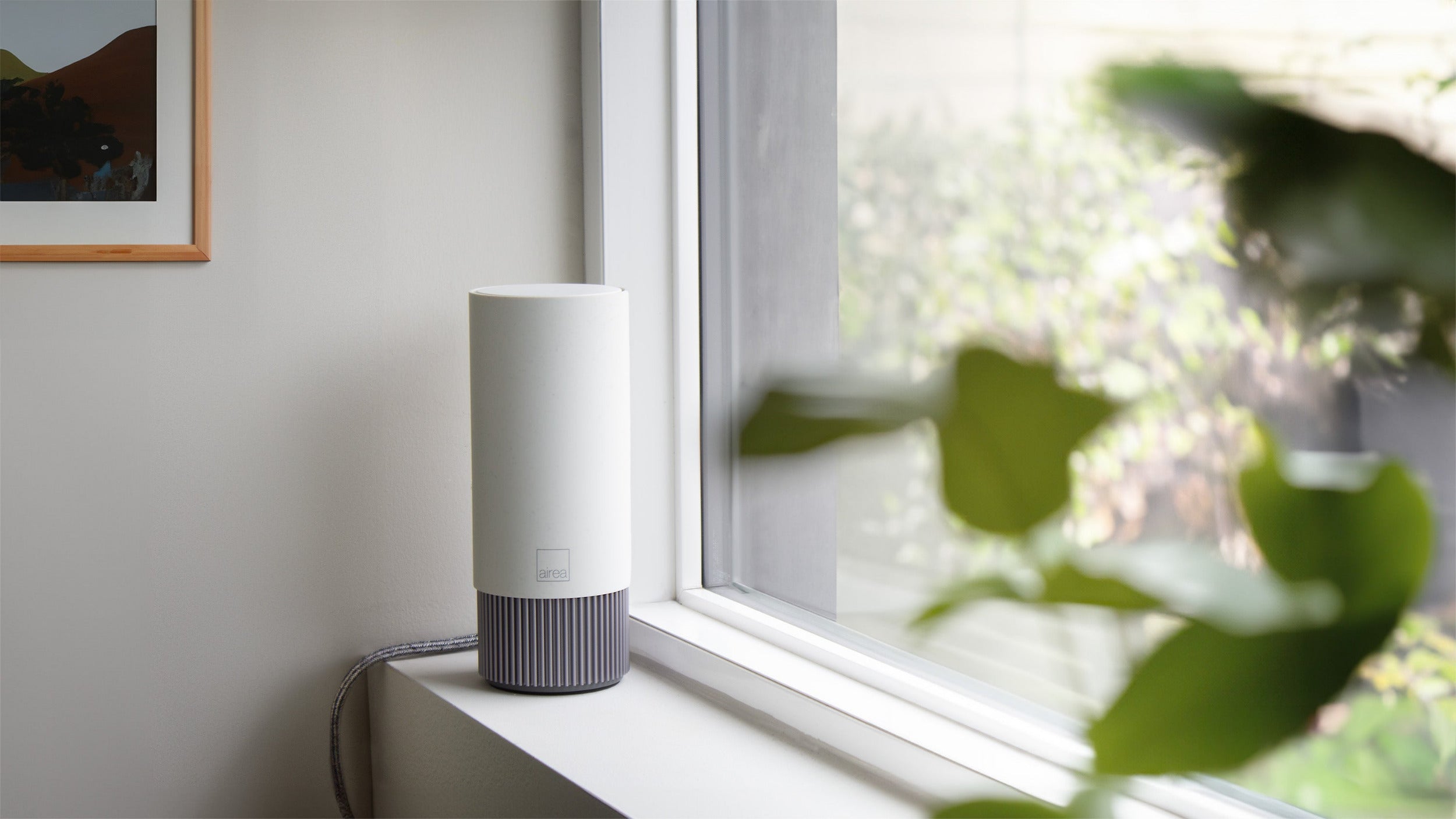 A compact Airea Space Purifier sitting on a clean shelf in a small apartment building providing peace-of-mind.