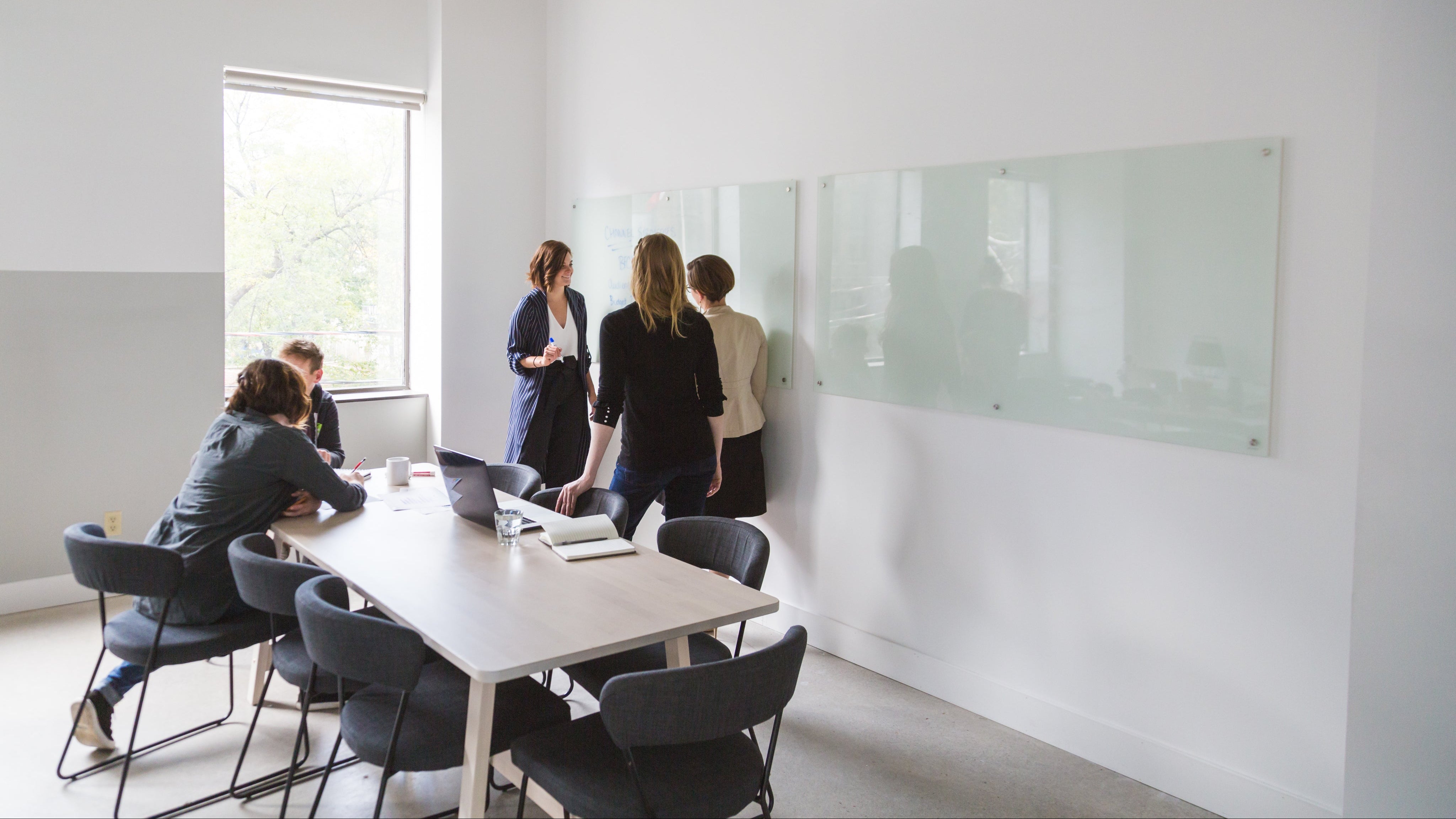 A crowded office space with coworkers collaborating.